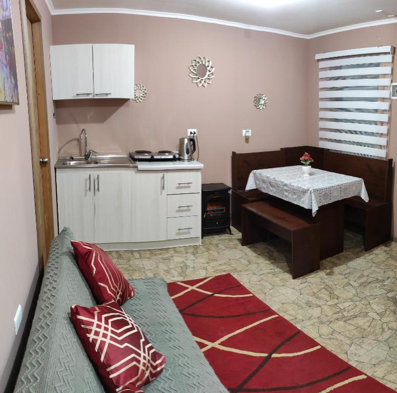 a kitchen with a couch and a table in a room at Departamentos Entre Lagos in Licán Ray