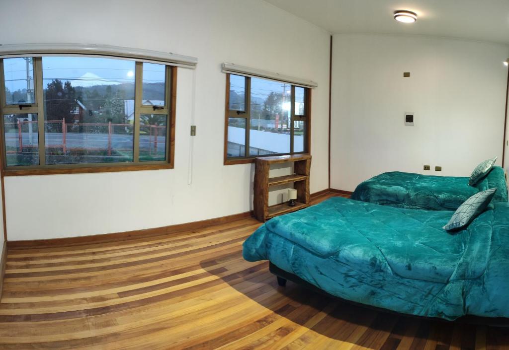a bedroom with a bed and a large window at Entre Volcanes in Licán Ray