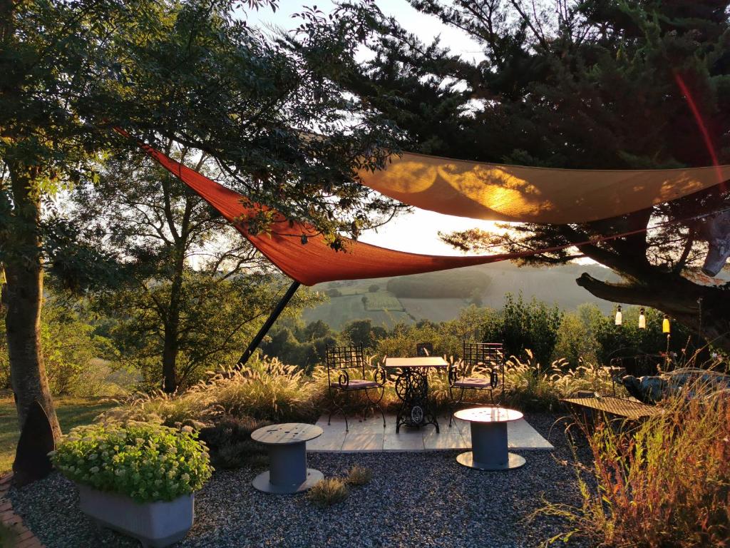 a hammock hanging from a tree in a garden at LA VIE EST BELLE 