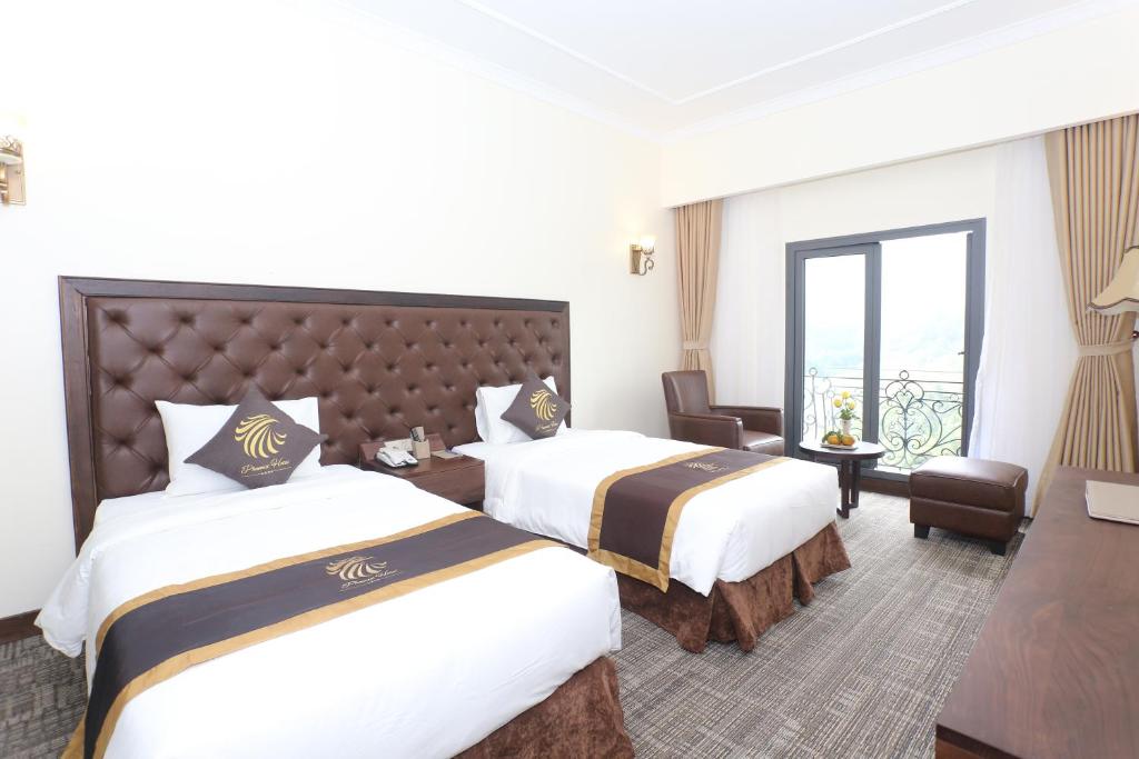 Postel nebo postele na pokoji v ubytování Phoenix Hotel Hà Giang
