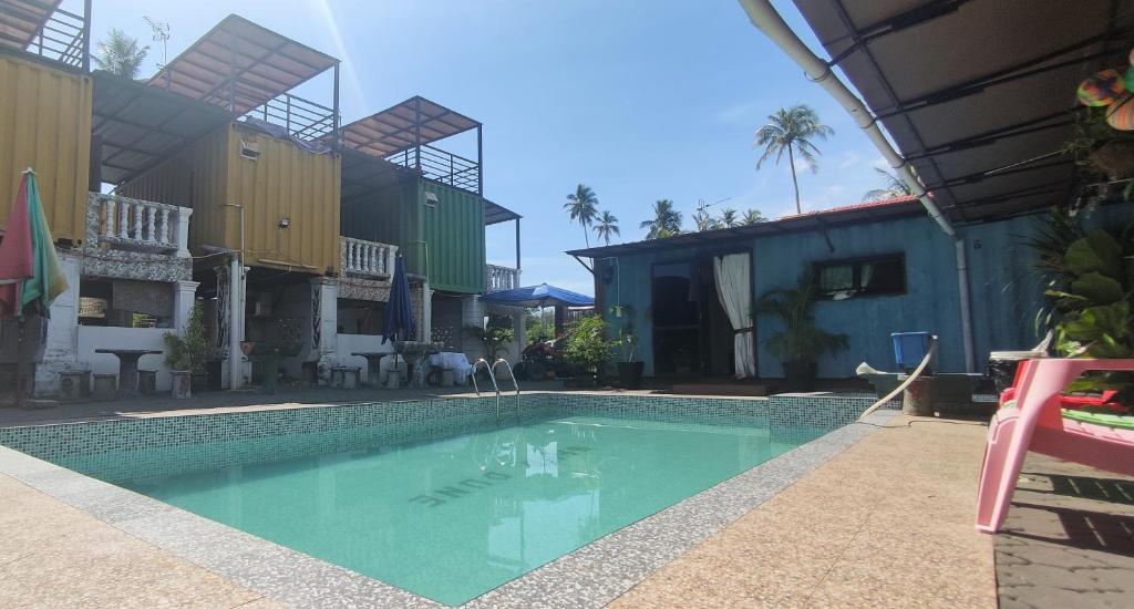 a swimming pool in the middle of a house at Sand Dune Villa in Kampong Beting Lintang