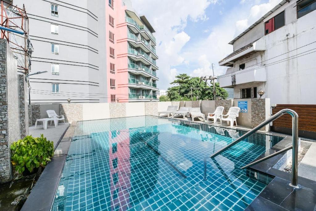 a swimming pool on the side of a building at The ESSE Hotel Pattaya in Pattaya South