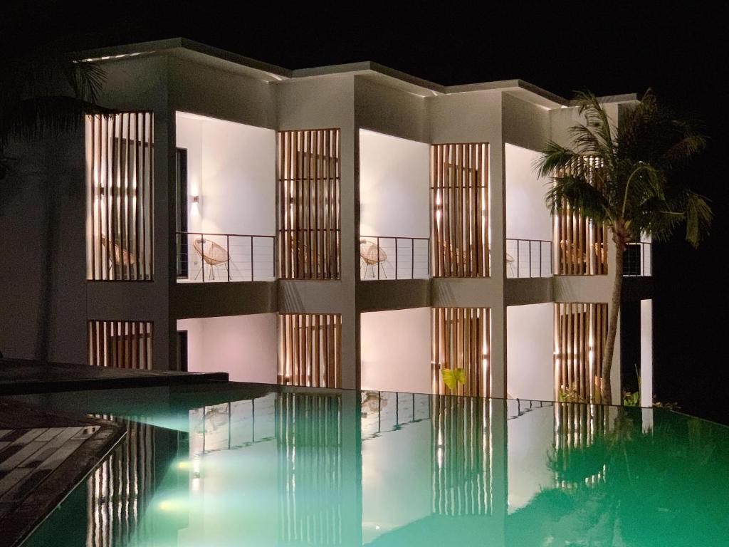 a building with a swimming pool at night at Trogon's Perch in San Isidro