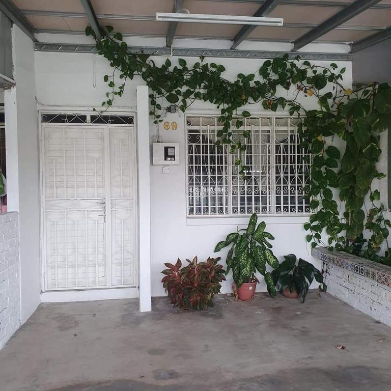 a garage with two doors and plants in it at Homestay Cempaka Star in Ipoh