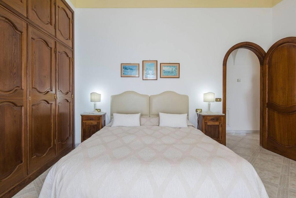 a bedroom with a large bed with two night stands at B&B Mamma Rosa Positano in Positano