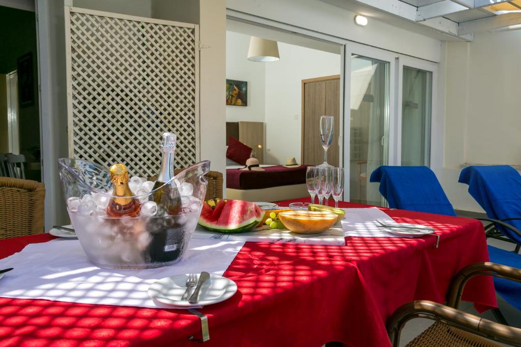 a table with a red table cloth on a red table at Fitosinn Hotel in Paphos