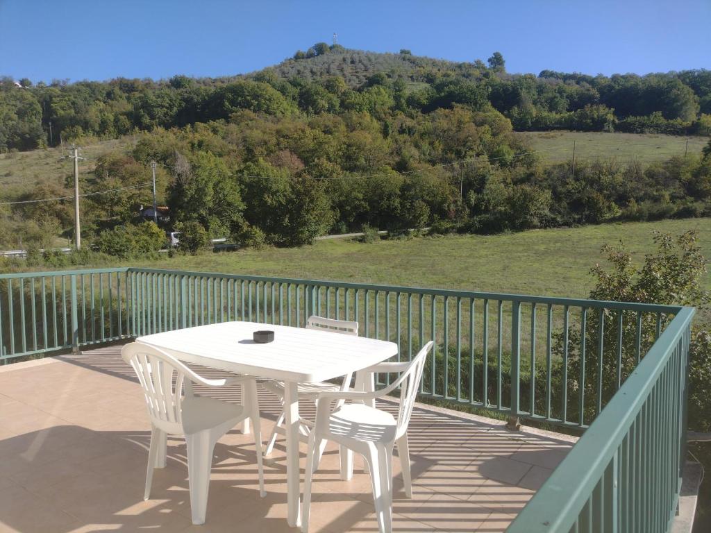 a white table and chairs on a deck with a view at Casa Le Piane in Strettura