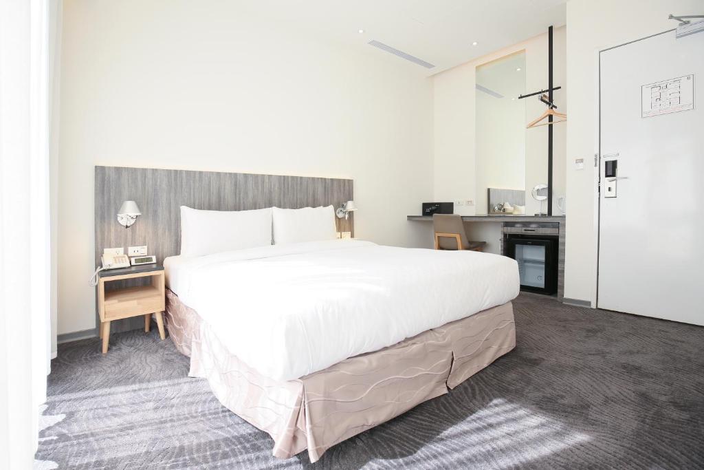 Postel nebo postele na pokoji v ubytování Dandy Hotel - Tianjin Branch