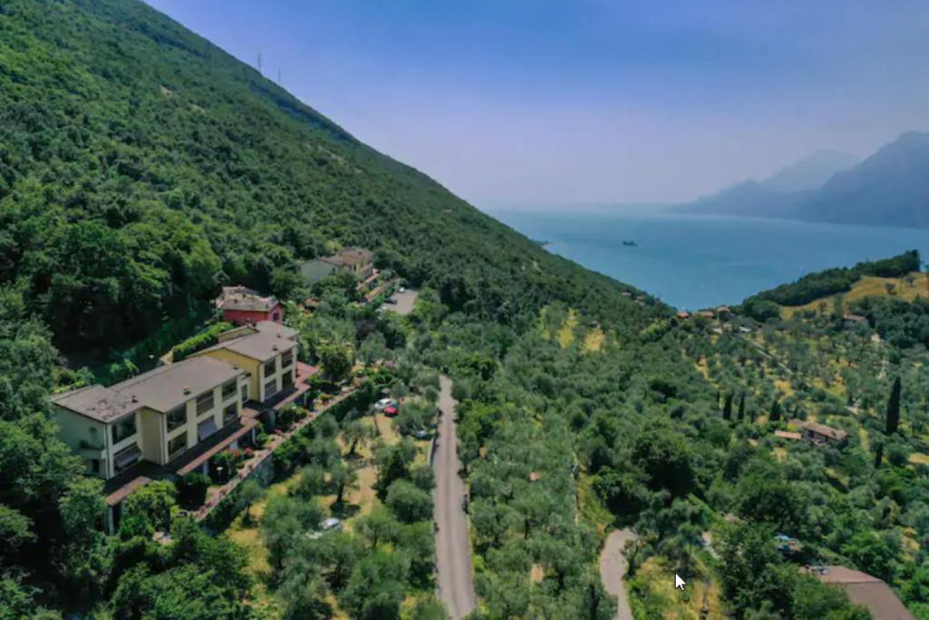an aerial view of a house on a hill at Flat in Garden Residence resort, Malcesine, Italy (with heated pool) in Malcesine