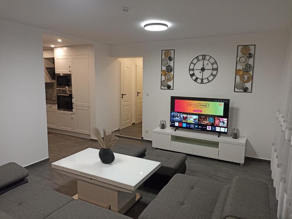 a living room with a couch and a tv and a table at EBS Paradies in Rheinhausen