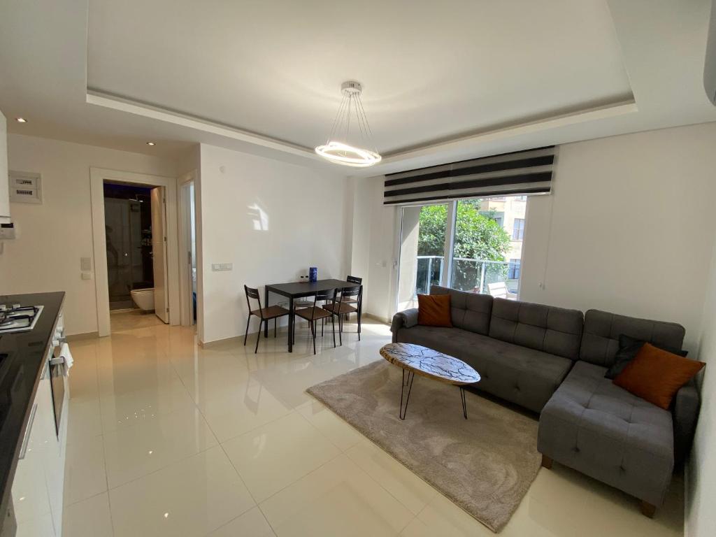 a living room with a couch and a table at Best Home 17 Kleopatra in Alanya