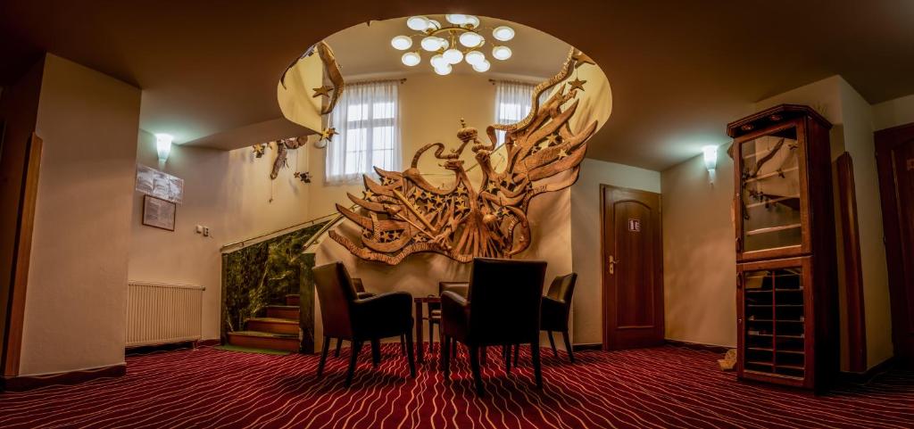 a dining room with a table and a large mirror at Hotel Brixen in Havlíčkŭv Brod