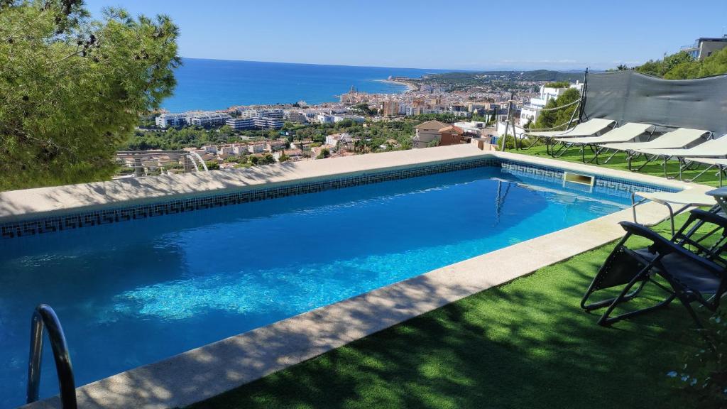 a swimming pool with a view of the ocean at The Villa Sunlight in Sitges
