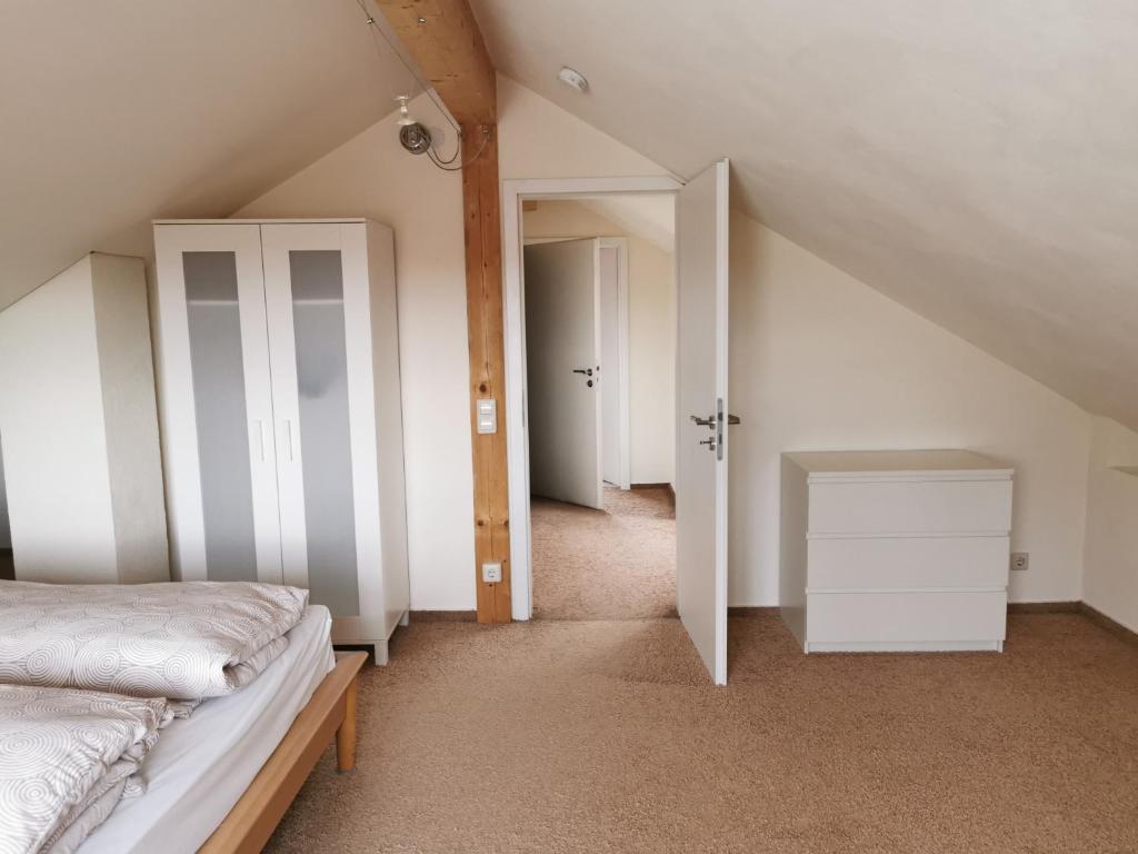 a attic room with a bed and a closet at Apartment an der Lindach in Kirchheim unter Teck