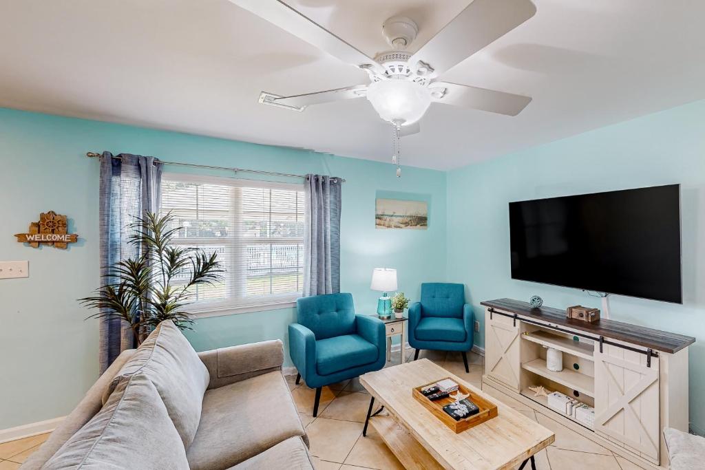 a living room with a couch and a flat screen tv at Woodland Shores #20 in Destin