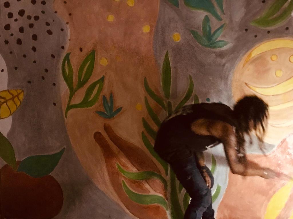 a painting of a person climbing up a tree at Corto Novo Maison d'hôtes-Camping in Nosy Be