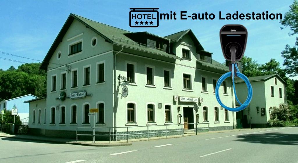 a building with a parking meter in front of it at Hotel Bielatal in Olbernhau