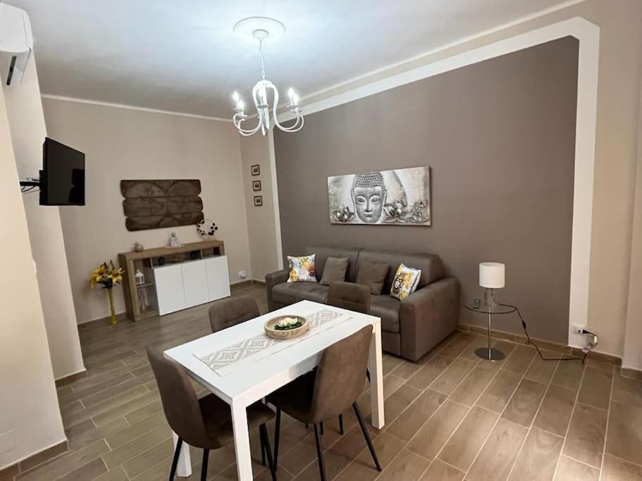 a living room with a table and a couch at ATTICO BRICCARELLO -Intero Appartamento- Elegant Suite with FREE WIFI near PalaAlpitour and Sporting Club Torino-Olimpyc Stadium in Turin