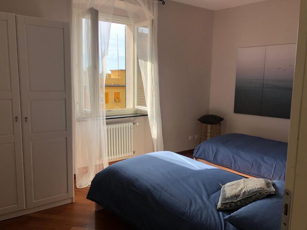 a bedroom with two beds and a window at Casa mia a Nervi in Genoa