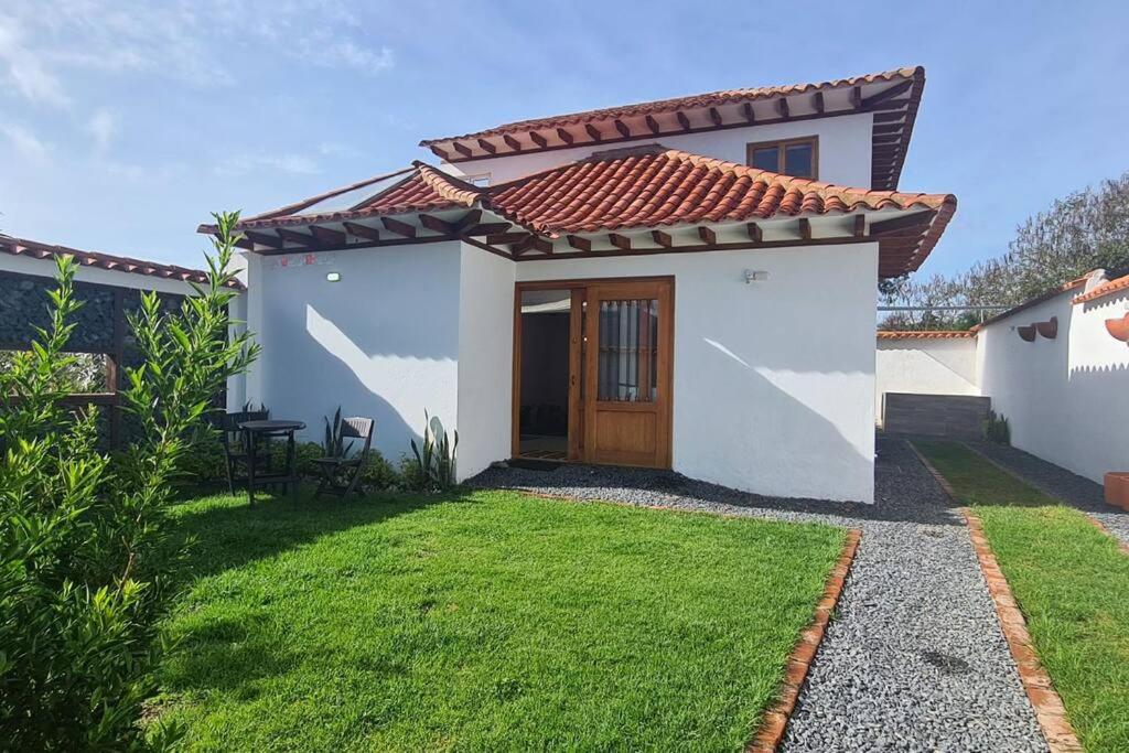 a small white house with a red roof at Villa RenaSer in Villa de Leyva