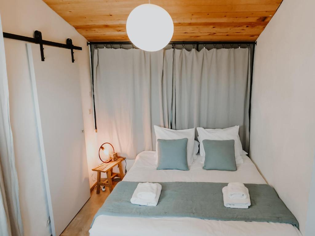 a bedroom with a bed with two towels on it at La Source in Oppedette