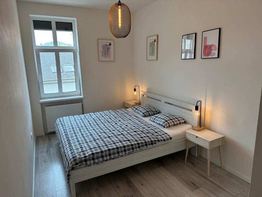 a bedroom with a bed and two lamps and a window at Lovely 2-bedroom apartment in centre of Bratislava in Bratislava