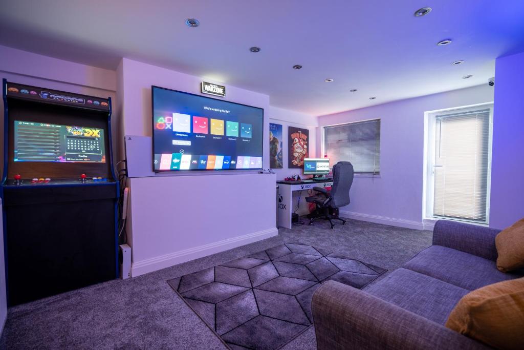 um quarto com uma sala de estar com um jogo de vídeo em Cavendish Cat and Gaming House em Blackpool