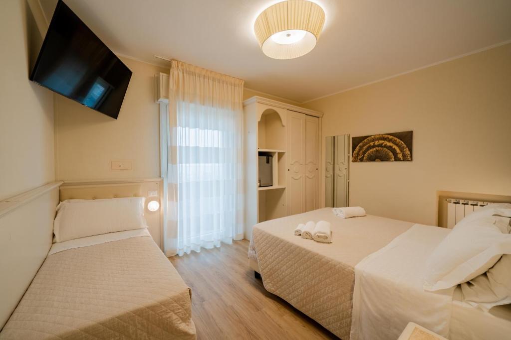 Postel nebo postele na pokoji v ubytování Hotel Orchidea
