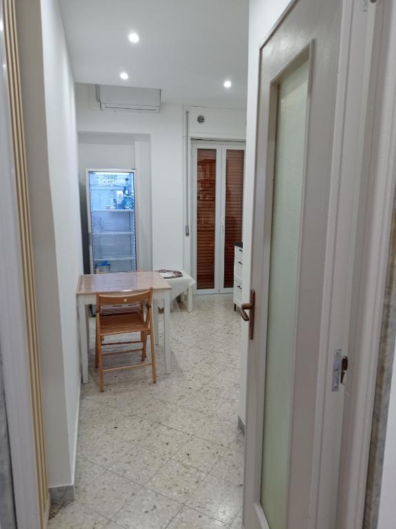 a hallway with a table and a chair in a room at CasaRA in Bari