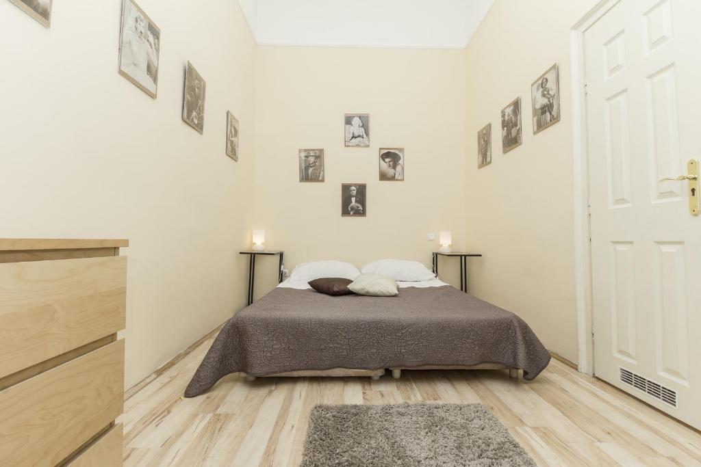 a bedroom with a bed and pictures on the wall at Budapest Bed and Breakfast in Budapest
