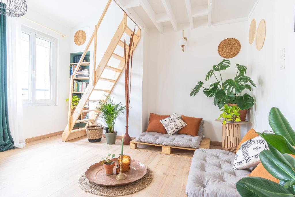 a living room with a couch and a staircase at La maison bohème in Le Havre