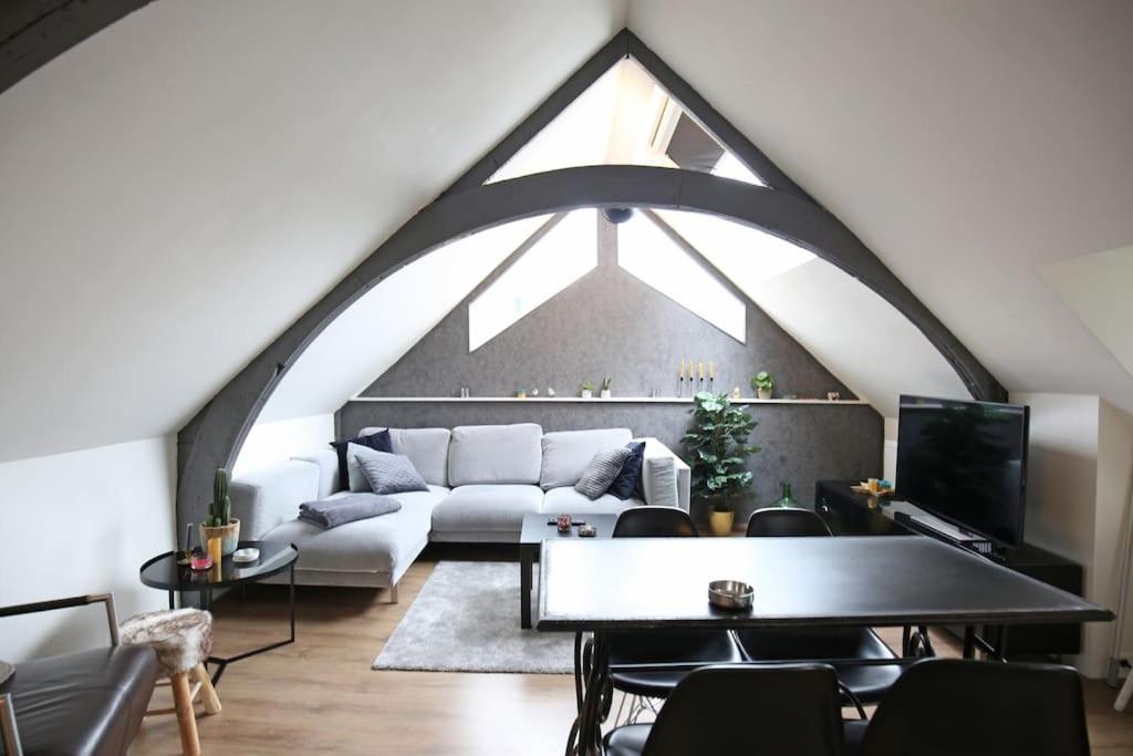 a living room with a white couch and a large window at Appartementen Purmerend B in Purmerend