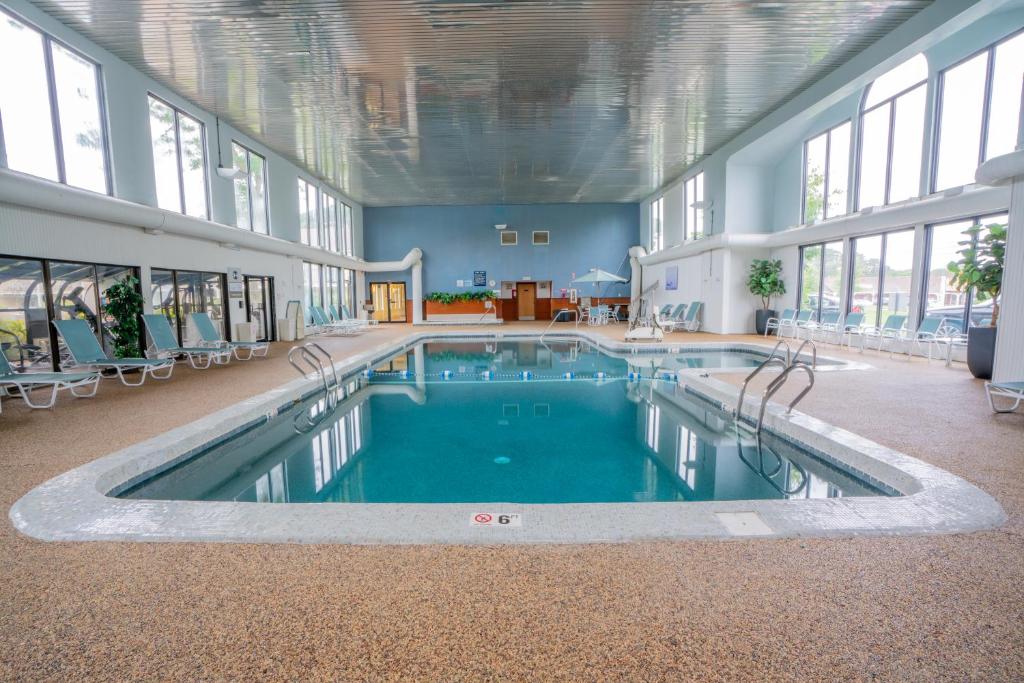 a large swimming pool in a large building with windows at All Seasons Resort, Trademark Collection by Wyndham in South Yarmouth