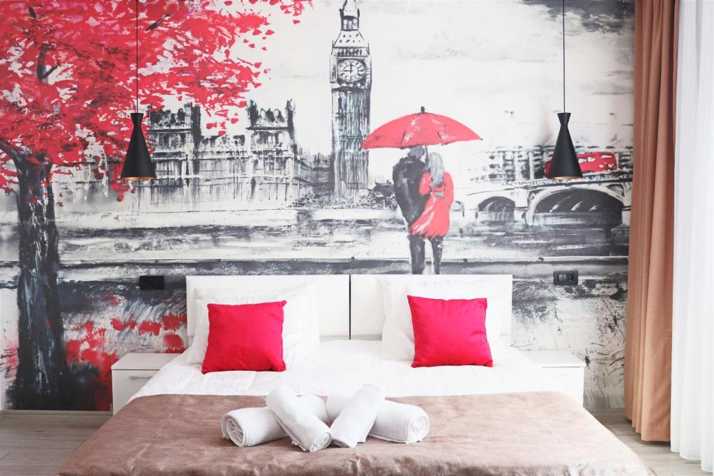 una camera da letto con un grande murale di un uomo e una donna con un ombrello di Cozy Apartment in Pristina a Pristina