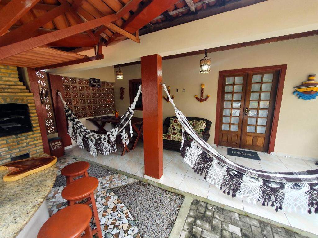 a porch with a hammock in a house at Antunes vila maragogi in Maragogi