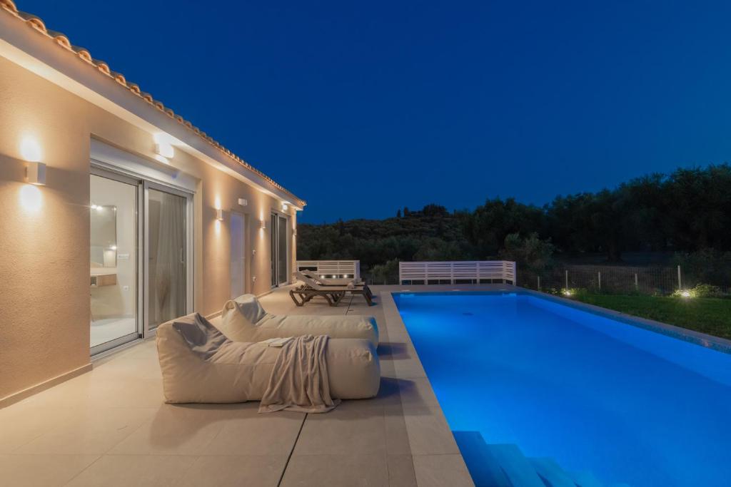 una casa con piscina di notte di Spartakos Luxury Villa 5 a Plános