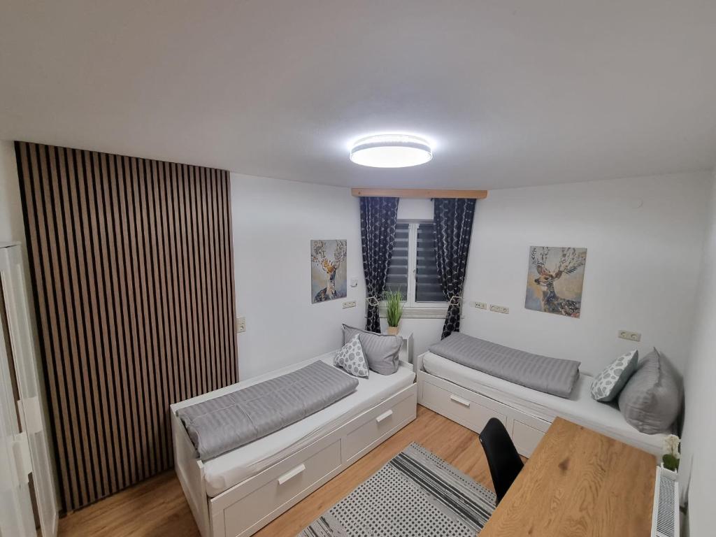 a living room with two beds and a table at Apartment Enarina in Telfs in Telfs