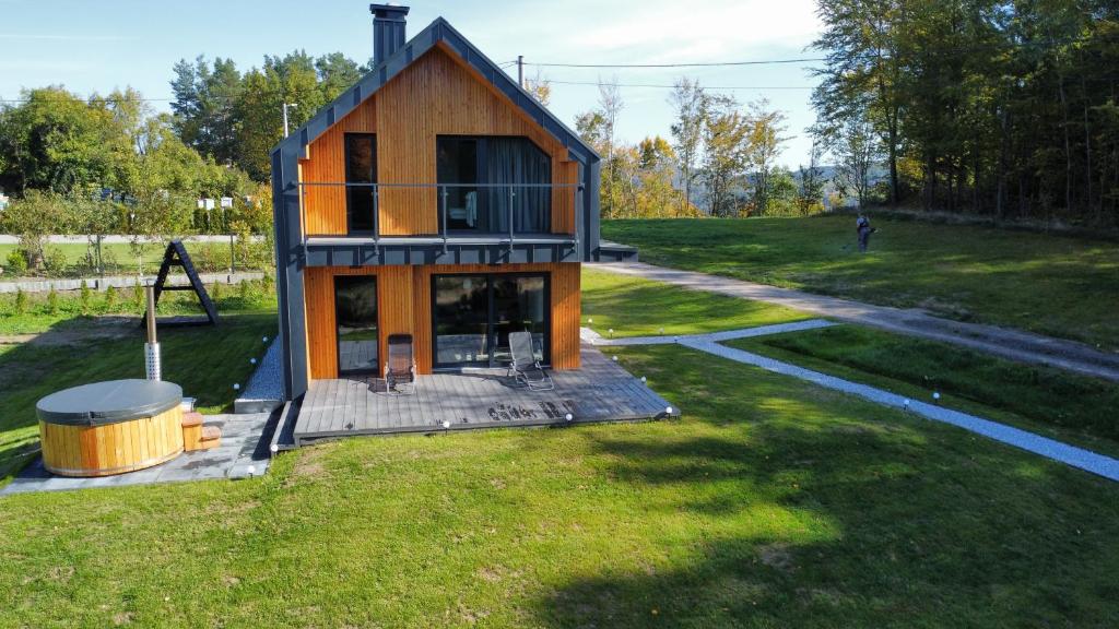 mały domek na środku podwórka w obiekcie Wood Lake Rożnów w mieście Rożnów