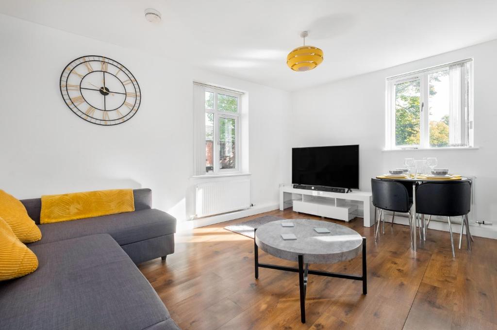 a living room with a couch and a tv at Meersbrook Luxury Duplex Apartment in Sheffield