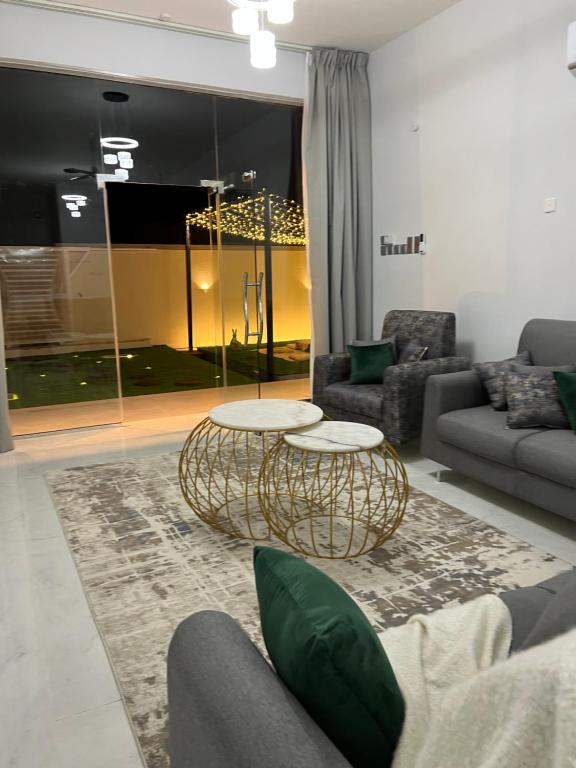 a living room with two tables and a couch at alsaif camp in Bidiyah
