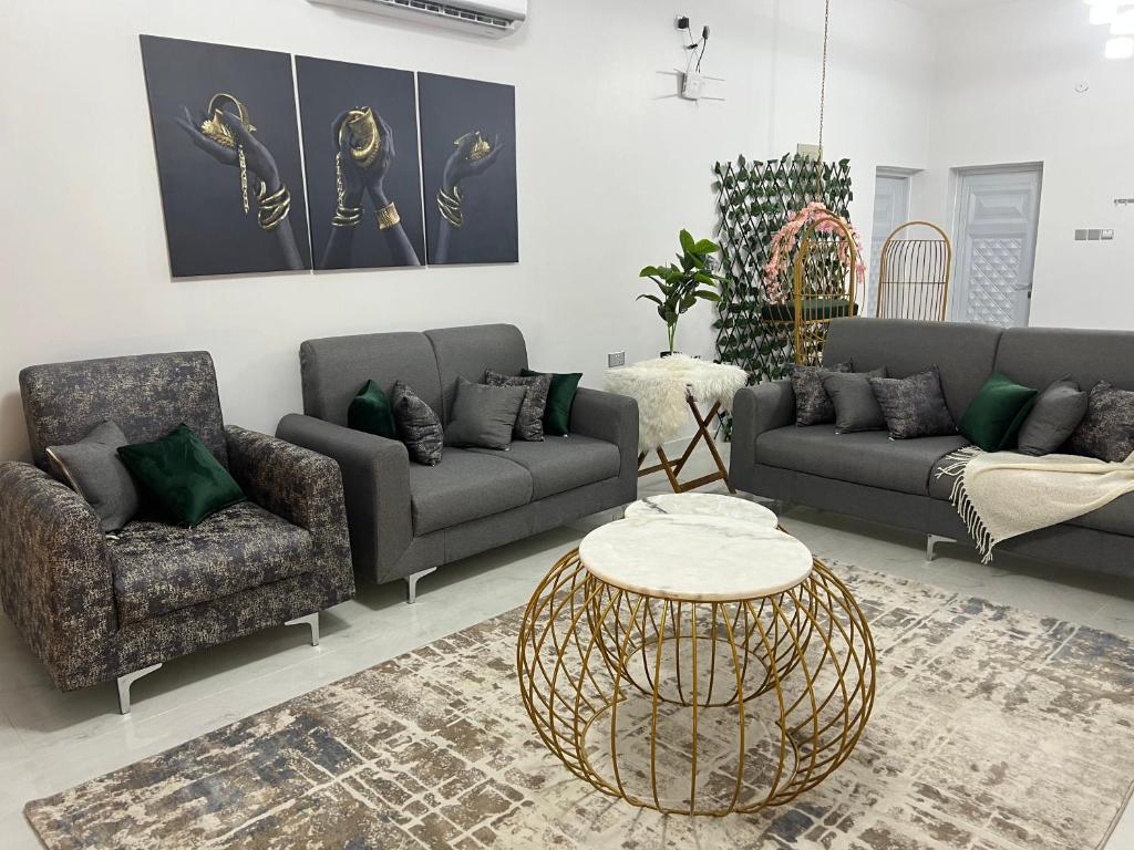 a living room with two couches and a table at alsaif camp in Bidiyah