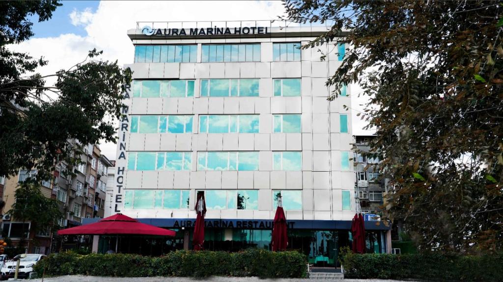 a building with a sign on top of it at AURA MARINA HOTEL in Istanbul