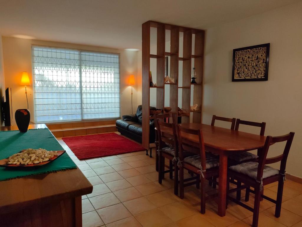 a kitchen and dining room with a table and chairs at Appt Morne la Loge in Pointe-à-Pitre
