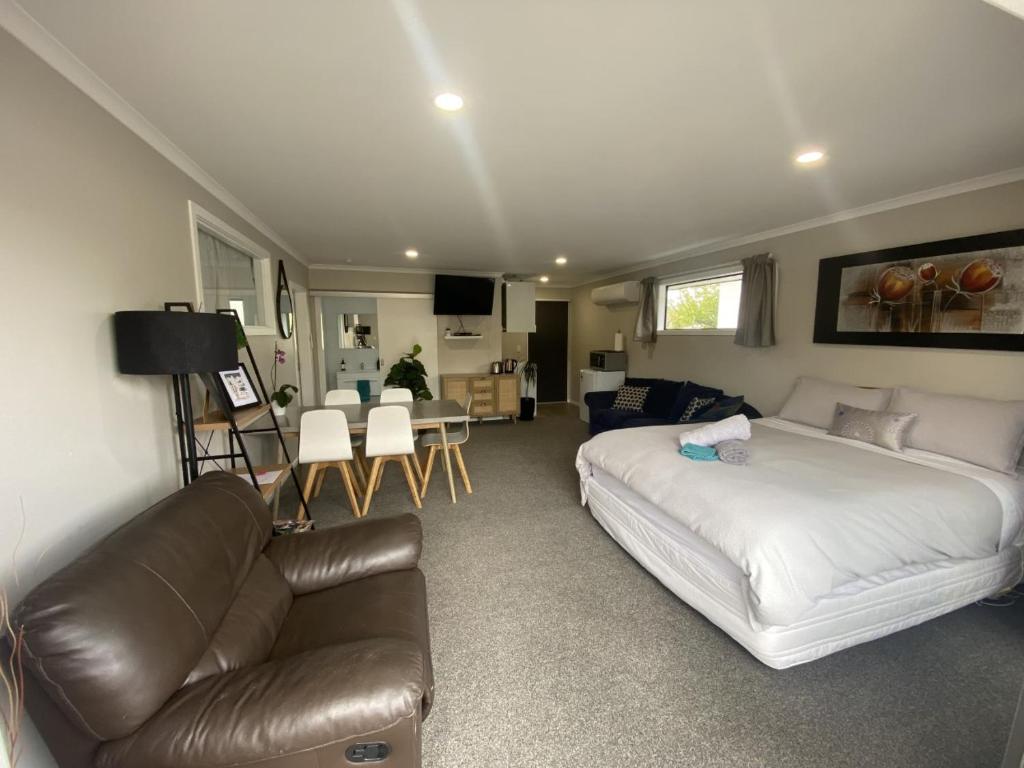 a bedroom with a bed and a couch and a living room at Location Location Location in Cromwell