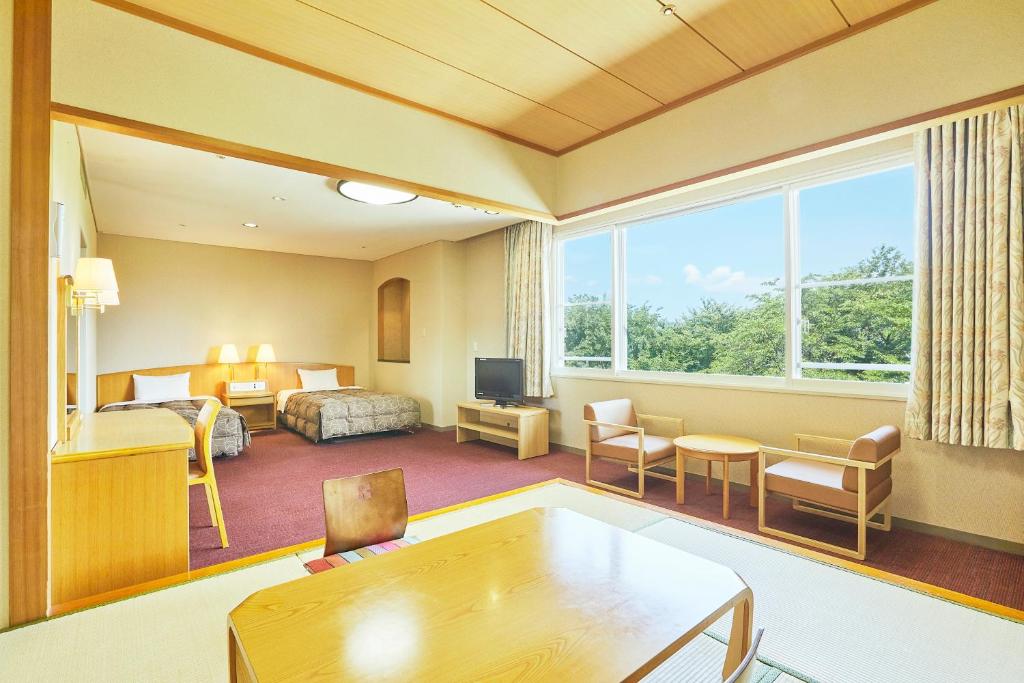 Postel nebo postele na pokoji v ubytování KAMENOI HOTEL Fukui