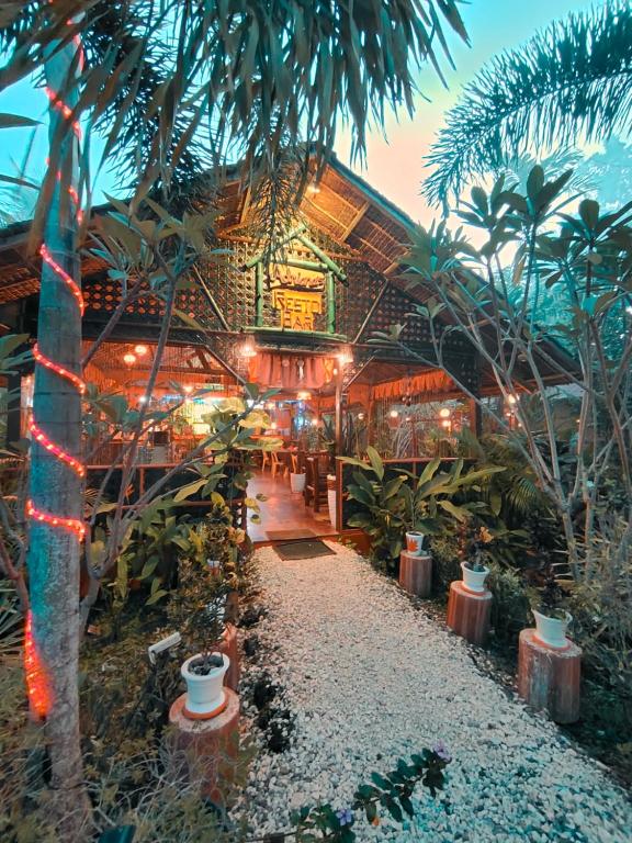 a building with a bunch of plants and lights at Adrianas Place in Panglao Island