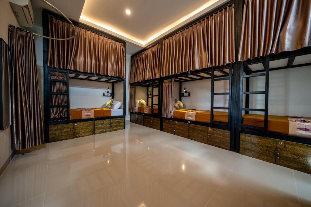 a bedroom with two beds and a large window at The Moon Hostel in Batununggul