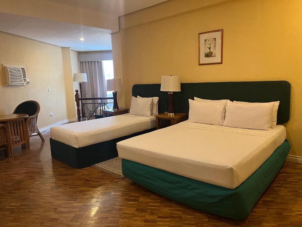 Postel nebo postele na pokoji v ubytování Coco Grande Hotel