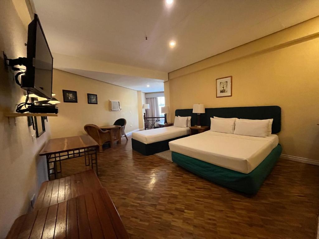 Postel nebo postele na pokoji v ubytování Coco Grande Hotel