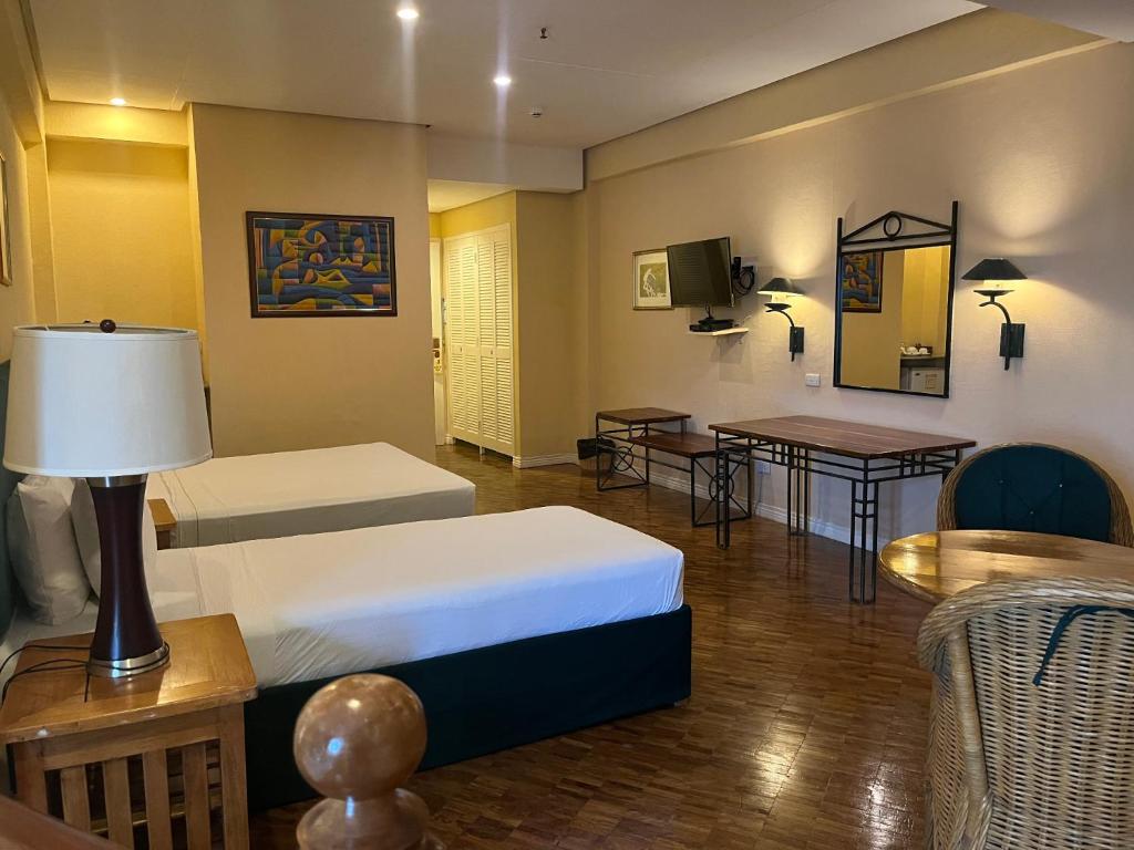 Postel nebo postele na pokoji v ubytování Coco Grande Hotel
